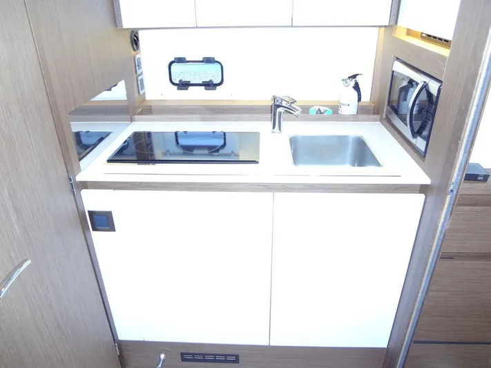 Lake Time, Austin, Tx Yacht Photos Pics Modern kitchen area in a 2017 Jeanneau Leader 36 yacht, featuring a sink and stove.