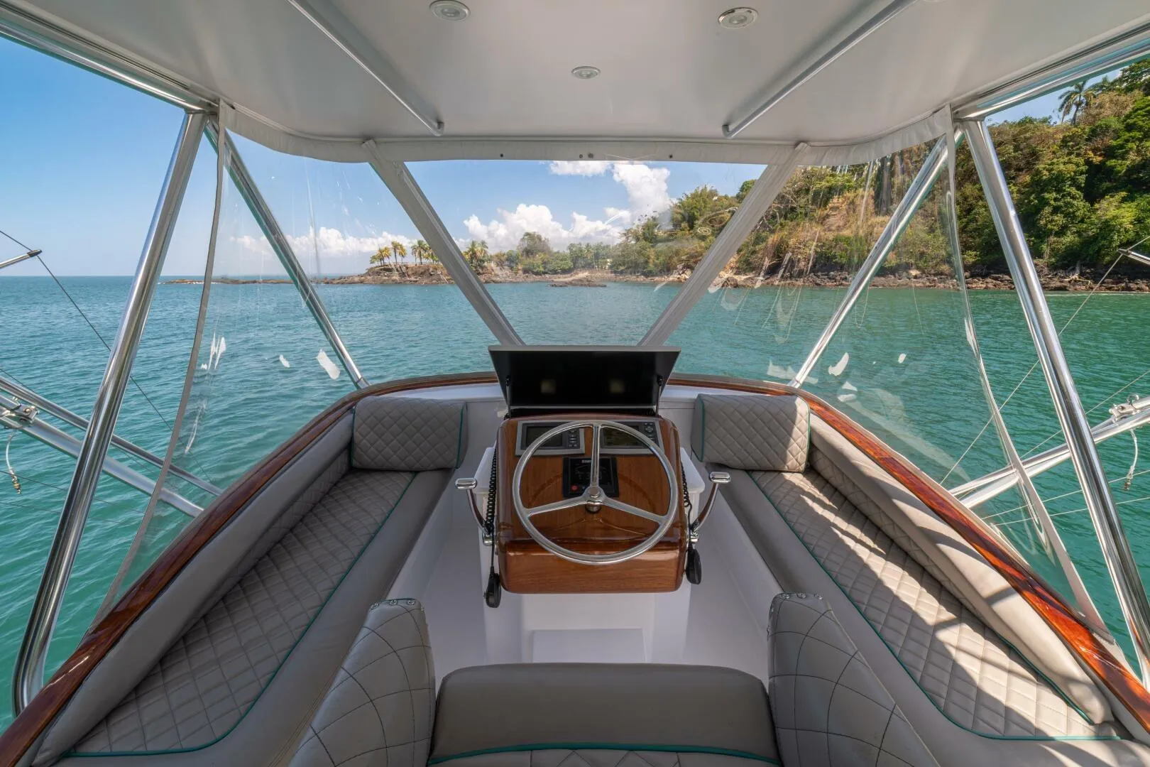 Interior view of 1991 Gamefisherman 40 boat with scenic ocean backdrop.