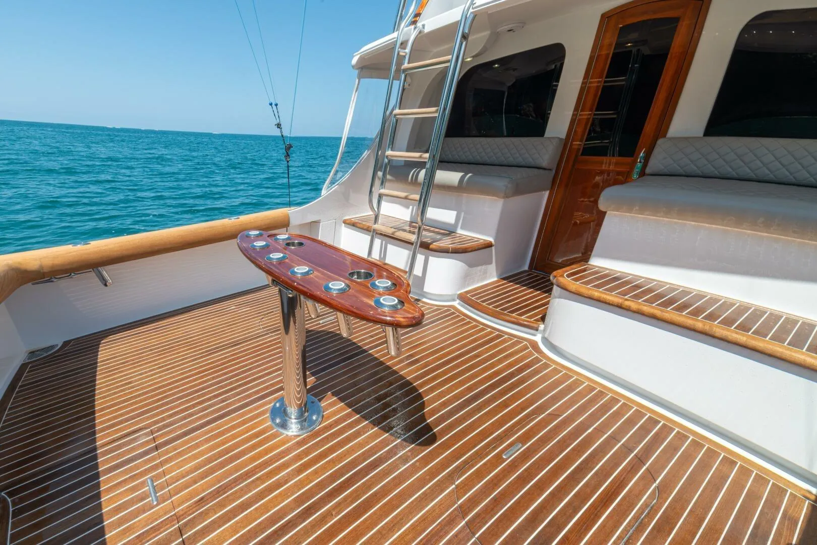 Luxurious 1991 Gamefisherman 40 yacht deck with wooden flooring and ocean view.