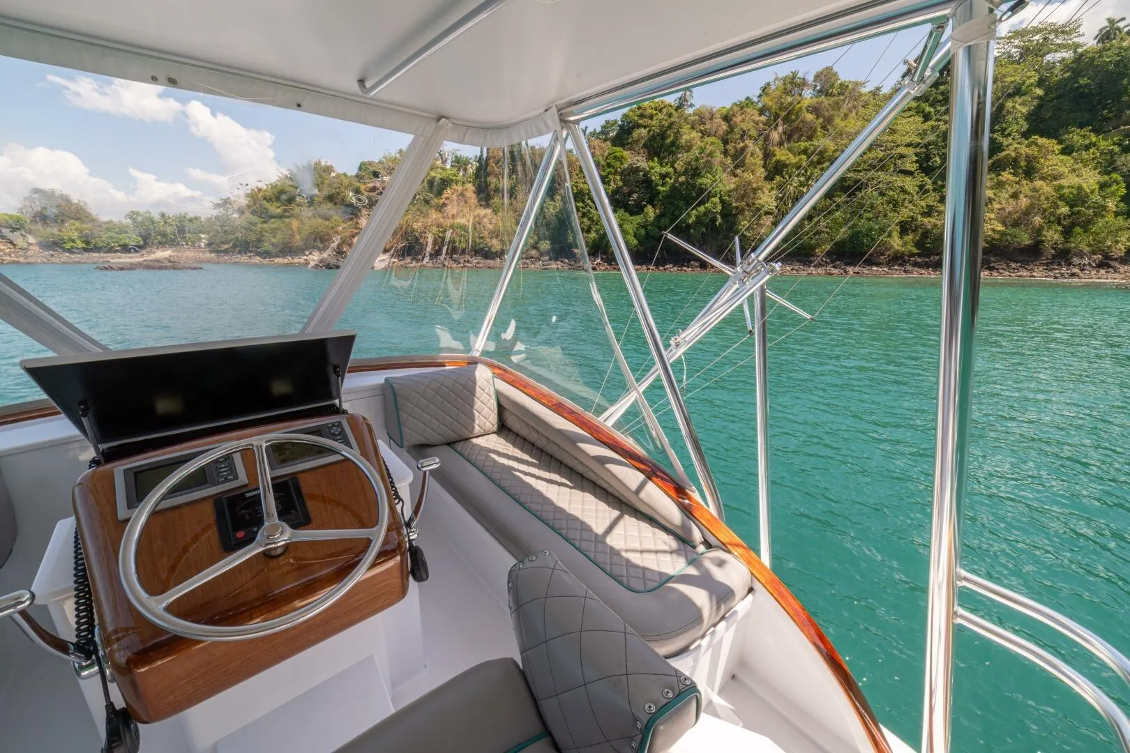 Helm of 1991 Gamefisherman 40 boat with scenic coastal view.