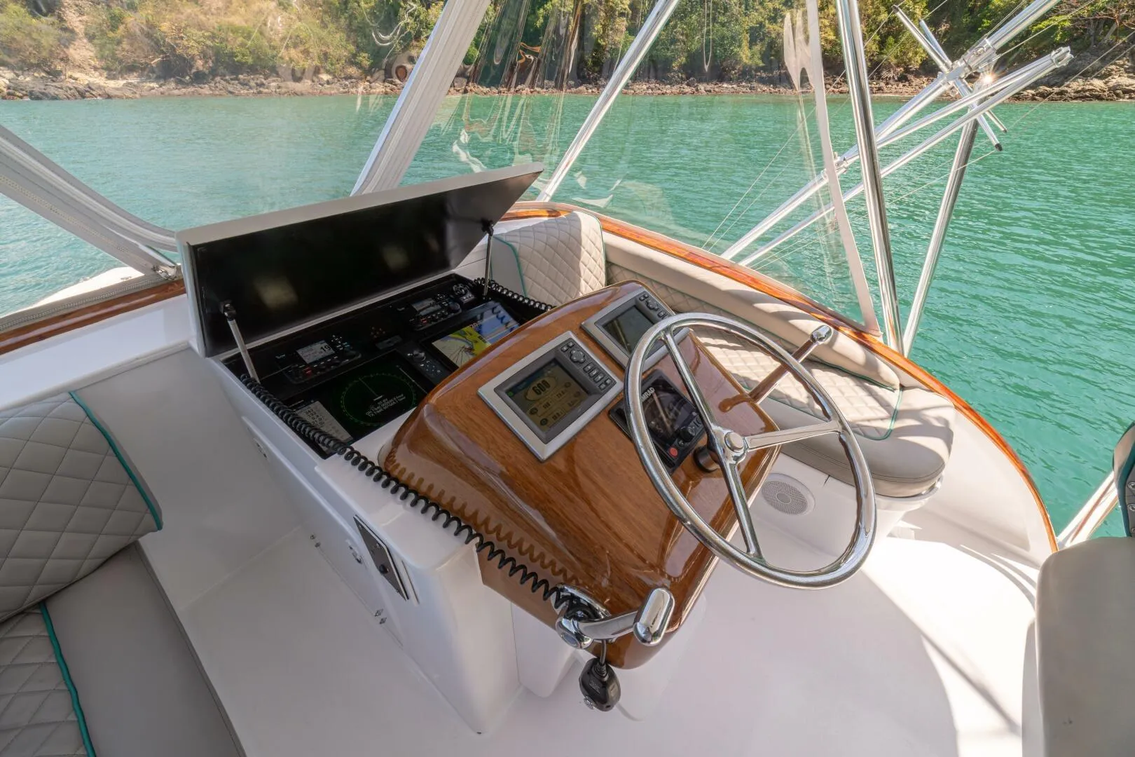 Helm of 1991 Gamefisherman 40 boat with steering wheel and navigation equipment.