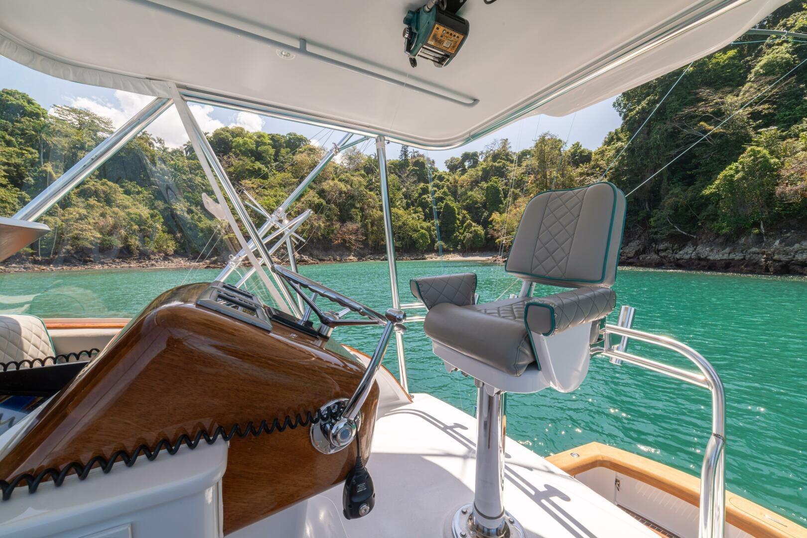 Helm of 1991 Gamefisherman 40 boat with scenic coastal view.