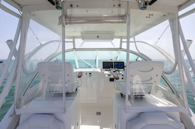  Yacht Photos Pics 2018 Albemarle 27 Express boat interior with dual captain seats and navigation equipment.