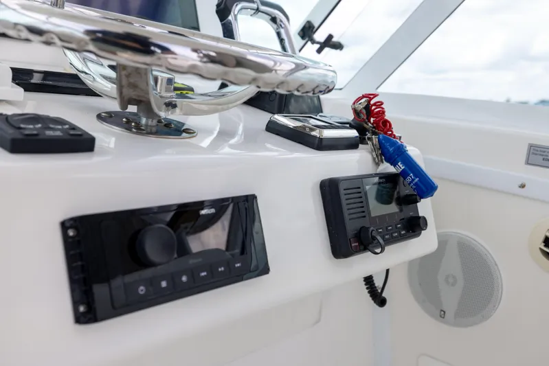  Yacht Photos Pics 2018 Albemarle 27 Express boat dashboard with controls and steering wheel.