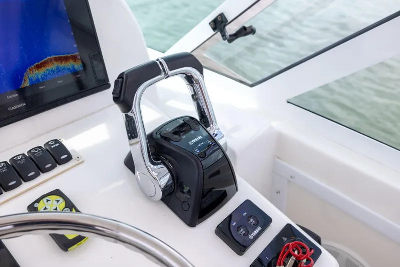  Yacht Photos Pics Control panel of 2018 Albemarle 27 Express boat with steering wheel and throttle.