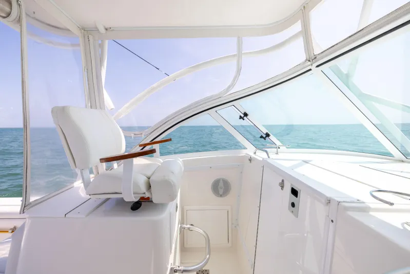 Yacht Photos Pics 2018 Albemarle 27 Express boat interior with ocean view, featuring a white captain's chair.