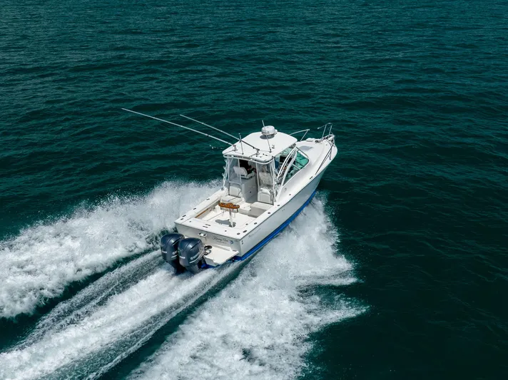  Yacht Photos Pics 2018 Albemarle 27 Express boat cruising on open water, rear view.