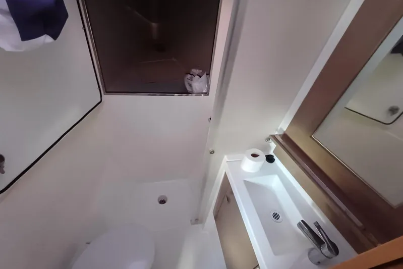  Yacht Photos Pics Bathroom interior of 2018 Fountaine Pajot Saona 47 catamaran, featuring sink and toilet.