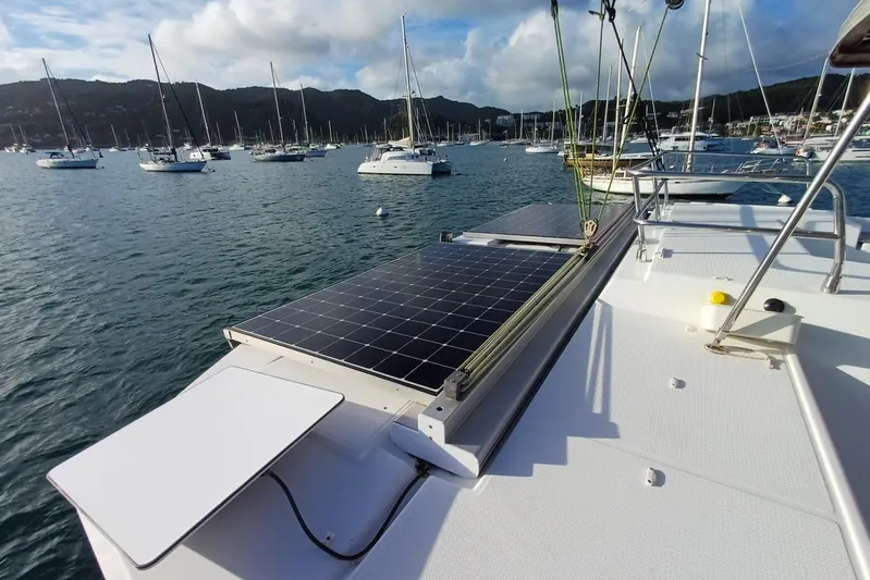  Yacht Photos Pics 2018 Fountaine Pajot Saona 47 catamaran with solar panels in a scenic marina.