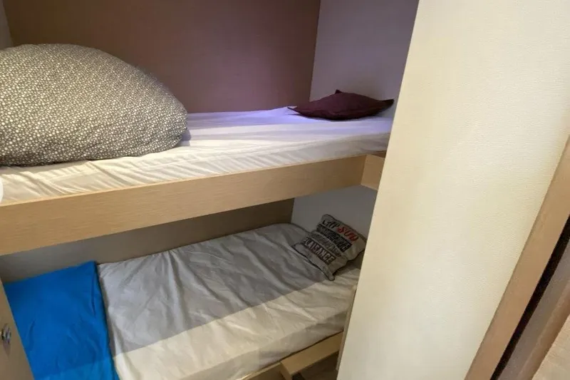  Yacht Photos Pics Bunk beds in 2018 Fountaine Pajot Saona 47 catamaran cabin, featuring cozy bedding.