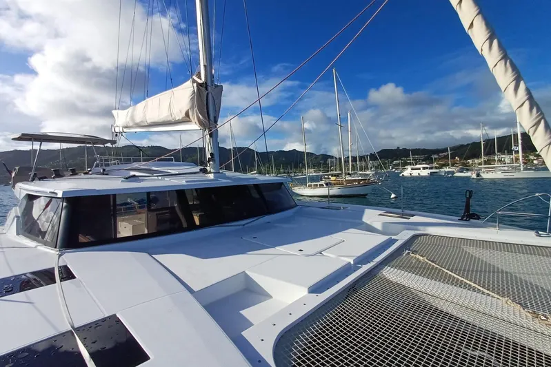  Yacht Photos Pics 2018 Fountaine Pajot Saona 47 catamaran docked in a scenic marina.