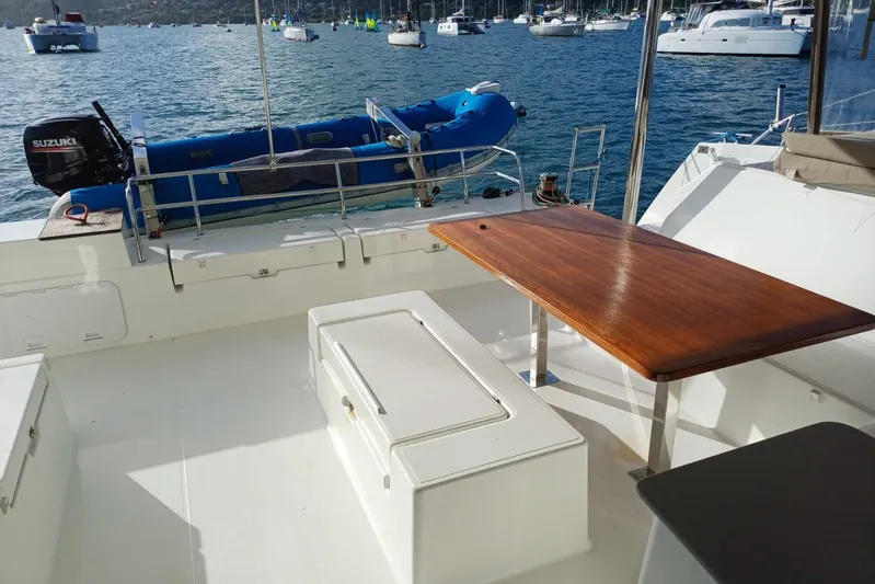  Yacht Photos Pics 2018 Fountaine Pajot Saona 47 catamaran deck with wooden table and ocean view.