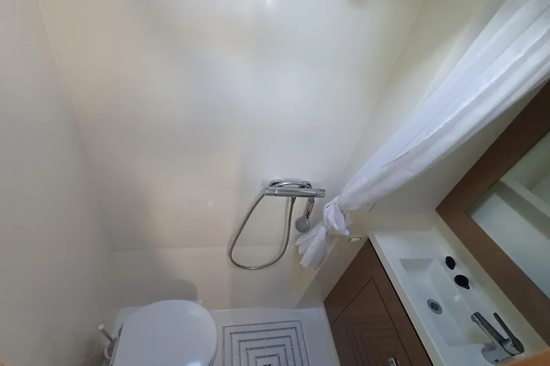  Yacht Photos Pics Bathroom interior of 2018 Fountaine Pajot Saona 47 catamaran, featuring shower and sink.