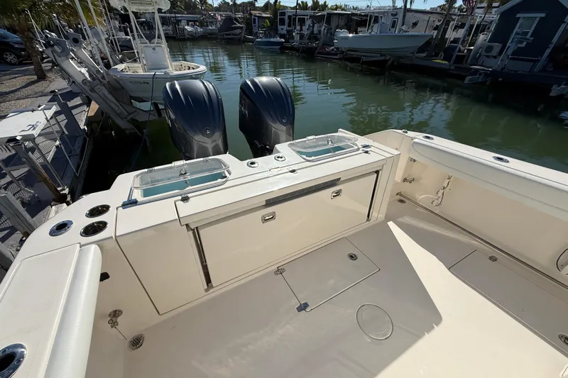  Yacht Photos Pics 2022 Cobia 320 Center Console boat with dual engines docked in marina.