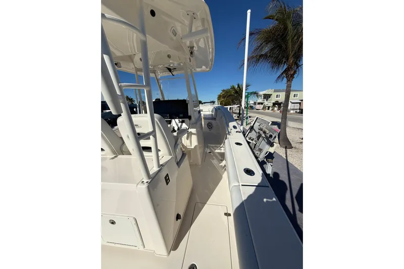  Yacht Photos Pics 2022 Cobia 320 Center Console boat, docked with palm trees in the background.