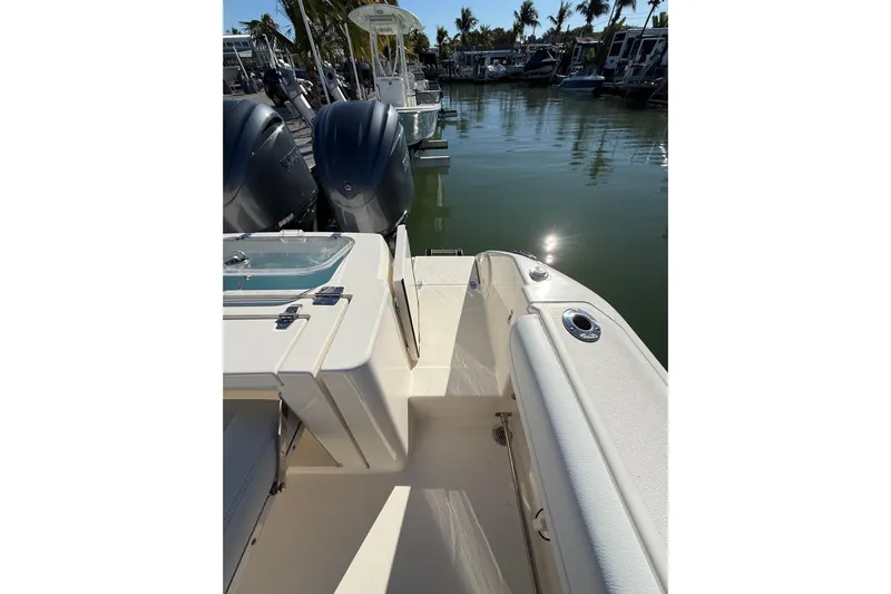  Yacht Photos Pics 2022 Cobia 320 Center Console boat docked, featuring dual engines and sleek design.