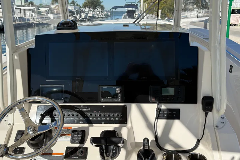  Yacht Photos Pics 2022 Cobia 320 Center Console dashboard with steering wheel and navigation controls.