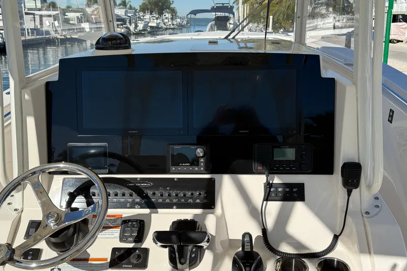  Yacht Photos Pics 2022 Cobia 320 Center Console dashboard with steering wheel, navigation screens, and controls.