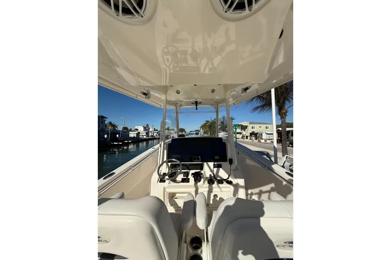  Yacht Photos Pics 2022 Cobia 320 Center Console boat interior with steering wheel and controls.
