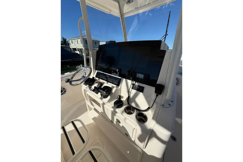  Yacht Photos Pics 2022 Cobia 320 Center Console boat dashboard with steering wheel and controls.