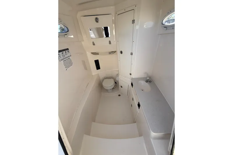  Yacht Photos Pics 2022 Cobia 320 Center Console boat interior with toilet and sink.