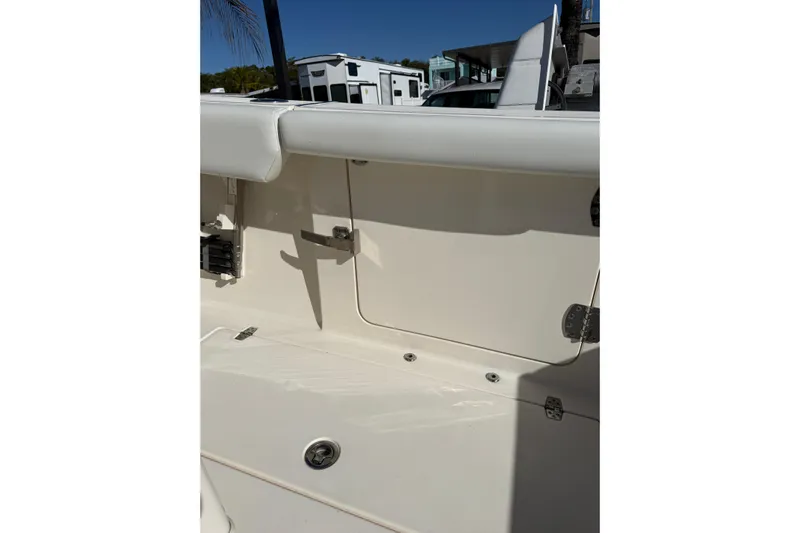  Yacht Photos Pics 2022 Cobia 320 Center Console boat interior detail with storage compartment and seating.