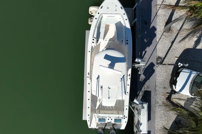  Yacht Photos Pics Aerial view of 2022 Cobia 320 Center Console boat docked by the water.