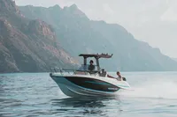2025 Quicksilver 705 Open boat cruising near rocky coastline.