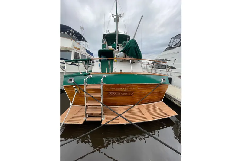 Amazing Grace Yacht Photos Pics 1983 Grand Banks 49 Classic yacht docked, rear view with wooden deck and green accents.