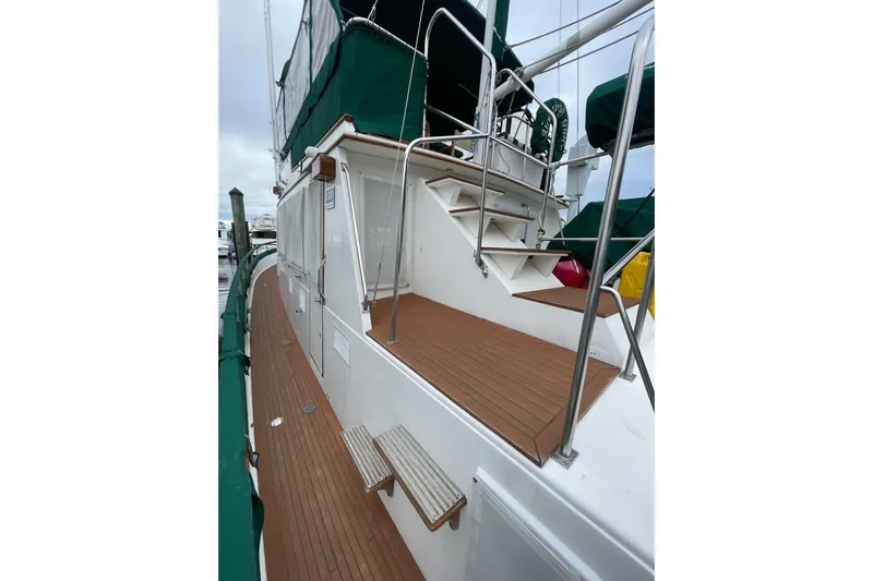 Amazing Grace Yacht Photos Pics 1983 Grand Banks 49 Classic yacht deck with wooden flooring and green canopy.