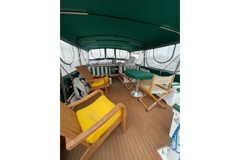 Amazing Grace Yacht Photos Pics 1983 Grand Banks 49 Classic yacht interior with green canopy and wooden seating.