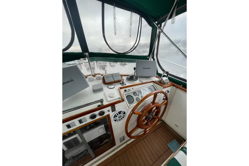 Amazing Grace Yacht Photos Pics Helm of 1983 Grand Banks 49 Classic yacht with wooden wheel and Garmin navigation.