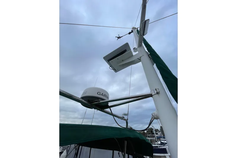 Amazing Grace Yacht Photos Pics Radar and antenna on 1983 Grand Banks 49 Classic yacht under cloudy sky.