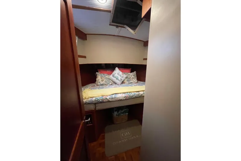 Amazing Grace Yacht Photos Pics Cozy cabin interior of 1983 Grand Banks 49 Classic yacht with decorative bedding.
