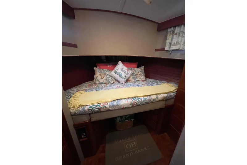 Amazing Grace Yacht Photos Pics Cozy cabin interior of 1983 Grand Banks 49 Classic with patterned bedding and pillows.
