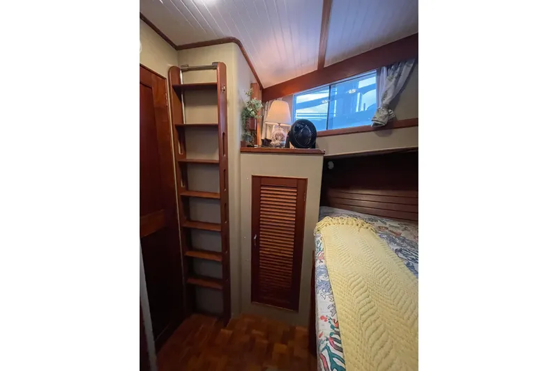 Amazing Grace Yacht Photos Pics Cozy cabin interior of 1983 Grand Banks 49 Classic yacht with wooden ladder and bed.