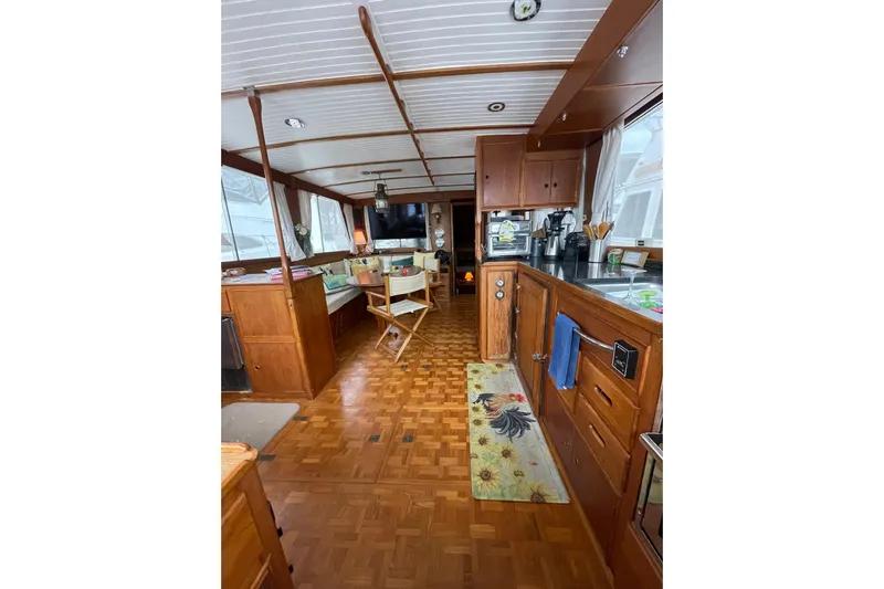 Amazing Grace Yacht Photos Pics Interior of 1983 Grand Banks 49 Classic yacht with wooden furnishings and cozy seating area.