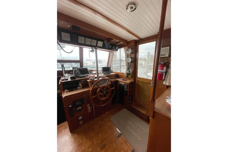 Amazing Grace Yacht Photos Pics 1983 Grand Banks 49 Classic helm with wooden wheel, navigation instruments, and gauges.