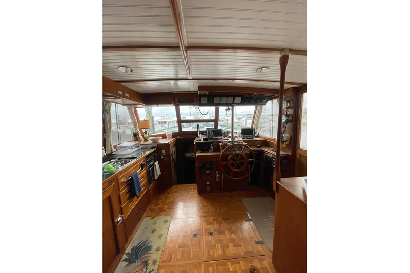 Amazing Grace Yacht Photos Pics 1983 Grand Banks 49 Classic yacht interior with wooden helm and navigation equipment.