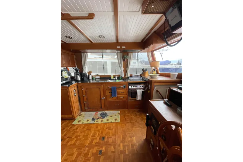 Amazing Grace Yacht Photos Pics Interior of 1983 Grand Banks 49 Classic yacht kitchen with wooden cabinetry and appliances.