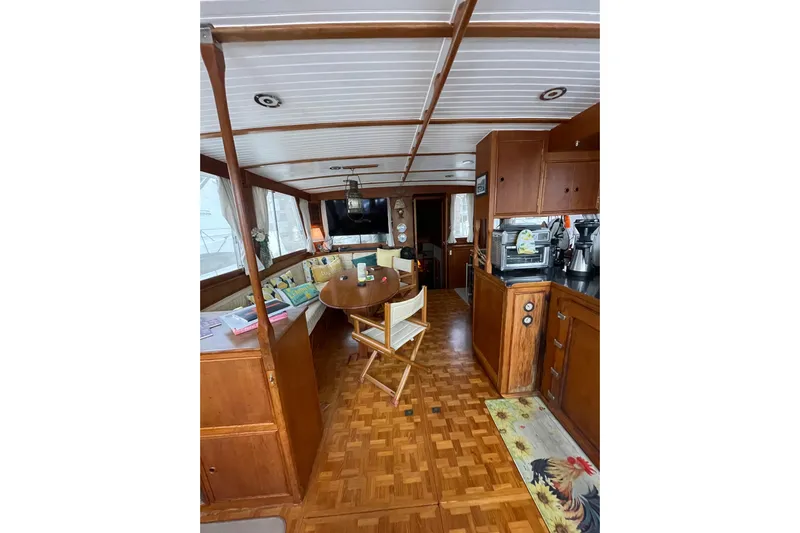 Amazing Grace Yacht Photos Pics Interior of 1983 Grand Banks 49 Classic yacht with wooden furnishings and cozy seating area.