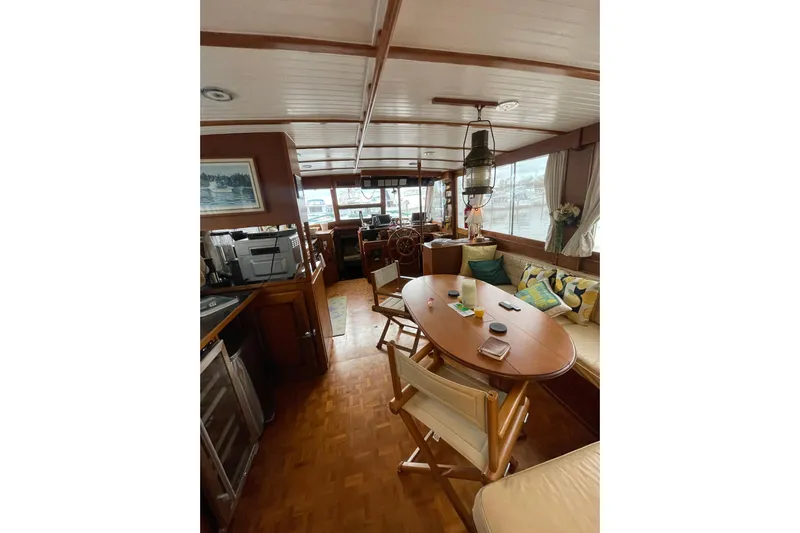 Amazing Grace Yacht Photos Pics Interior of 1983 Grand Banks 49 Classic yacht with wooden furnishings and cozy seating area.