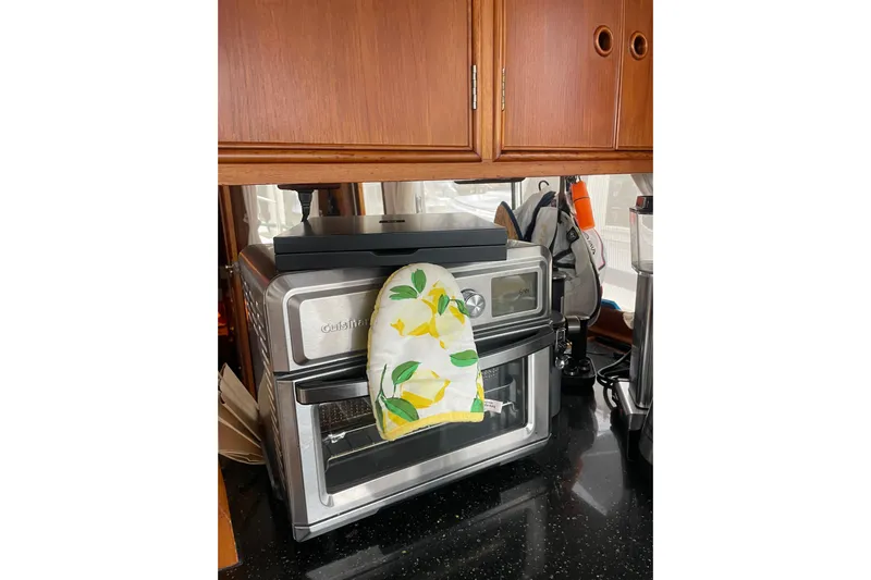 Amazing Grace Yacht Photos Pics Kitchen area in a 1983 Grand Banks 49 Classic with a Cuisinart oven and lemon-patterned mitt.