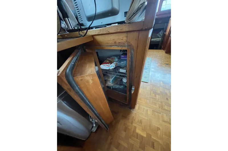 Amazing Grace Yacht Photos Pics Wooden cabinet with glass door in 1983 Grand Banks 49 Classic yacht interior.