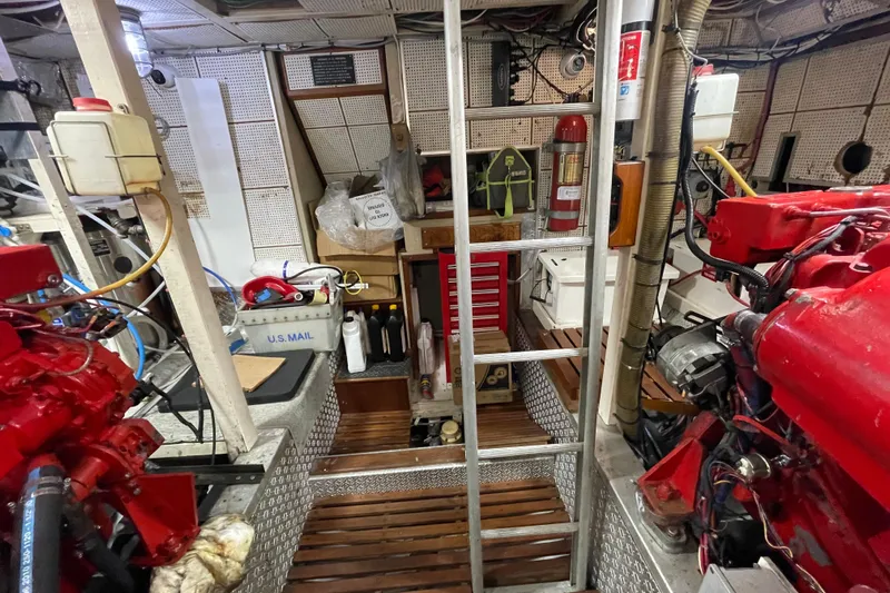 Amazing Grace Yacht Photos Pics Engine room of 1983 Grand Banks 49 Classic with red engines and maintenance tools.