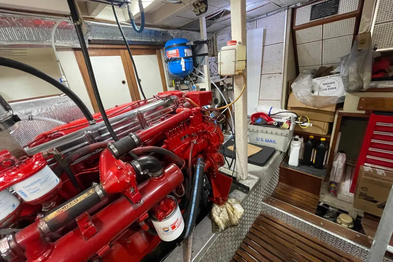 Amazing Grace Yacht Photos Pics Engine room of 1983 Grand Banks 49 Classic with red machinery and storage items.