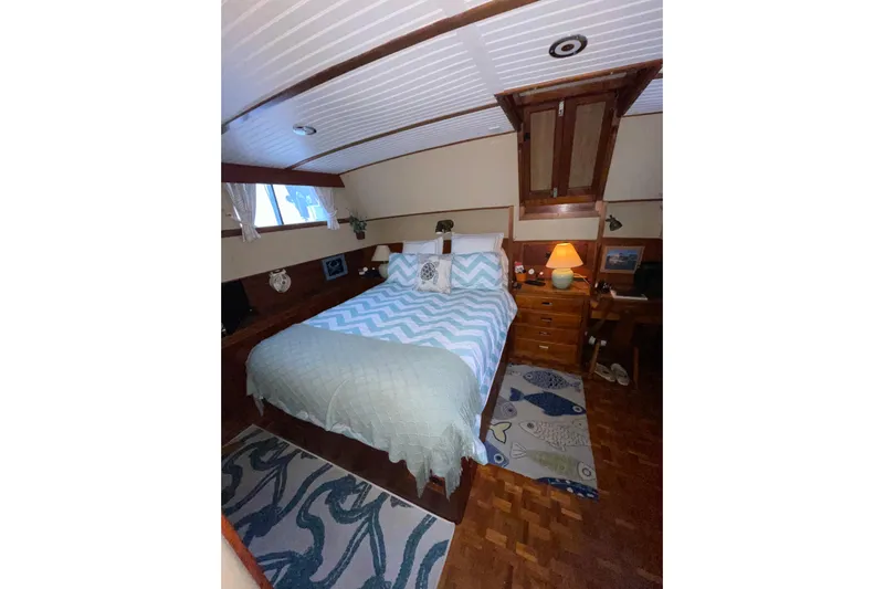 Amazing Grace Yacht Photos Pics Cozy bedroom in 1983 Grand Banks 49 Classic yacht with nautical decor and wooden furnishings.