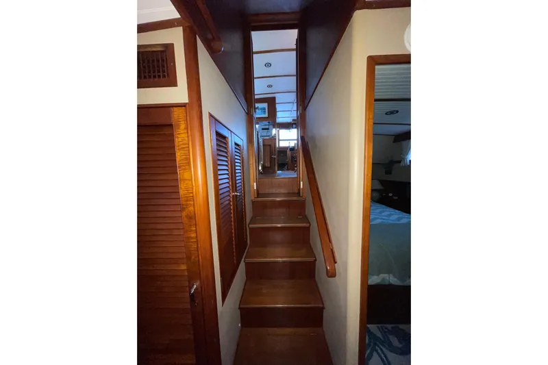 Amazing Grace Yacht Photos Pics Interior staircase of 1983 Grand Banks 49 Classic yacht, featuring wooden finishes.