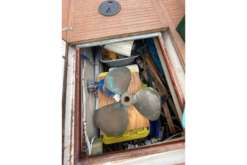 Amazing Grace Yacht Photos Pics Open hatch on 1983 Grand Banks 49 Classic, revealing storage with a large propeller.