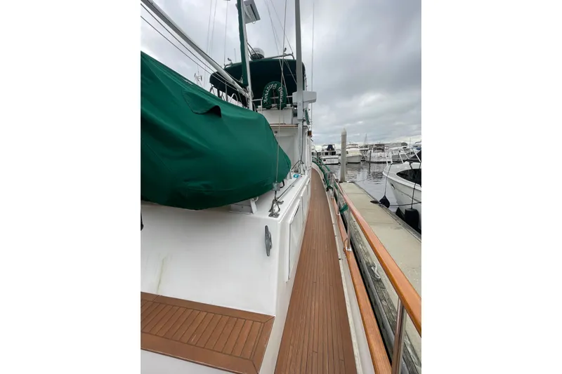 Amazing Grace Yacht Photos Pics 1983 Grand Banks 49 Classic yacht docked, featuring teak deck and green canvas cover.